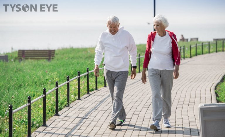 An active older couple walking outdoors knowing the common eye conditions