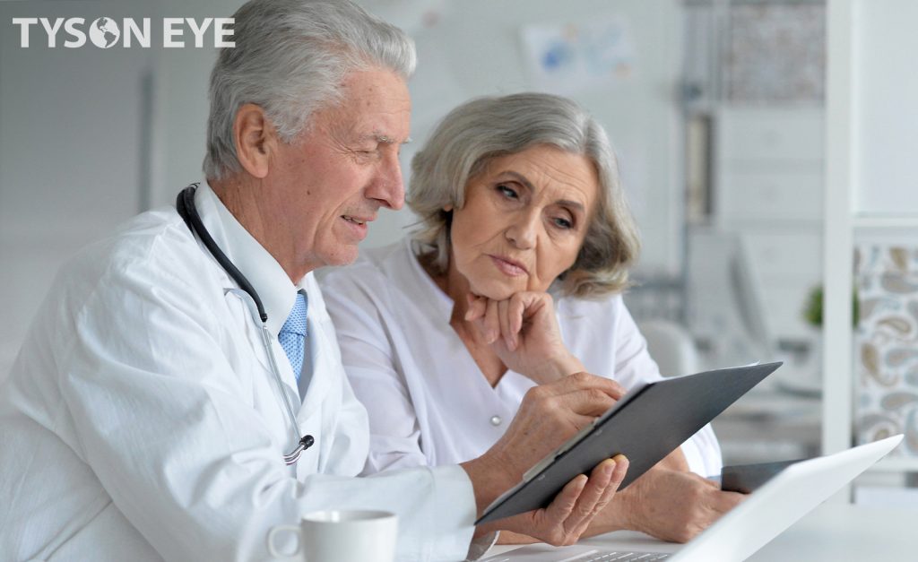 Male optometrist discussing Cataract IOL Options for surgery with female senior