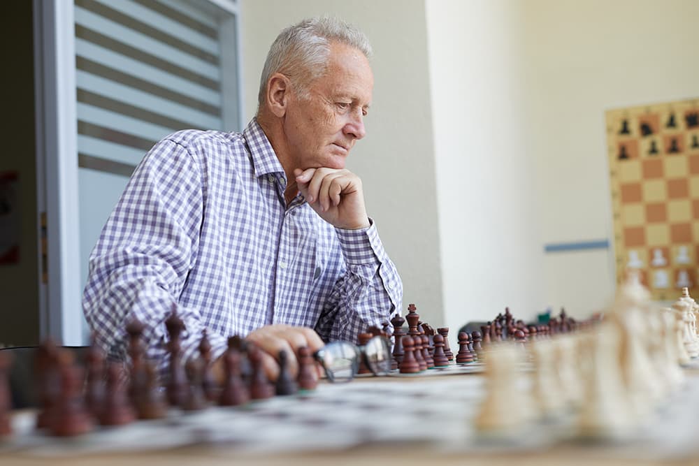 A Senior man playing chess