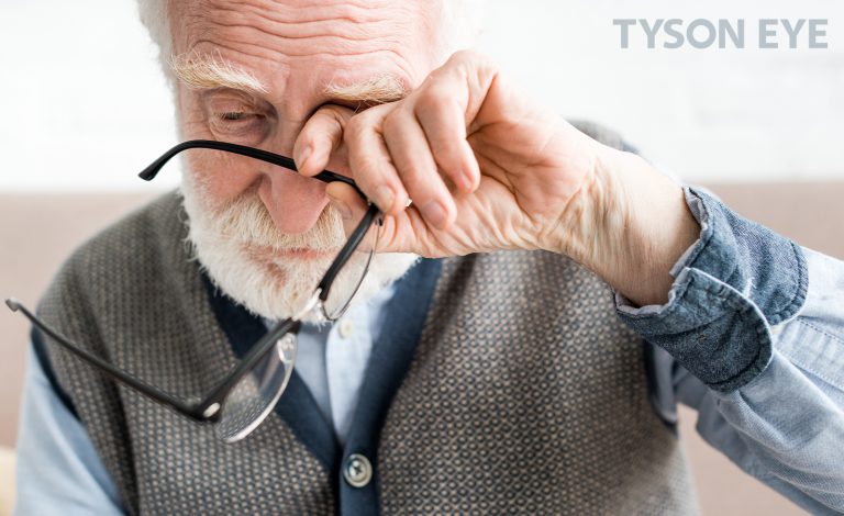 Older person rubbing his eye