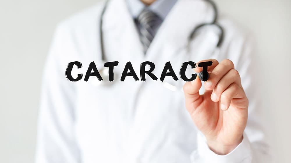 A doctor writing the word cataract