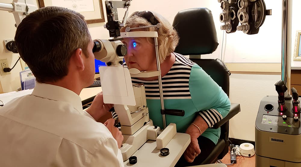 A woman having her eyes examined by an optometrist