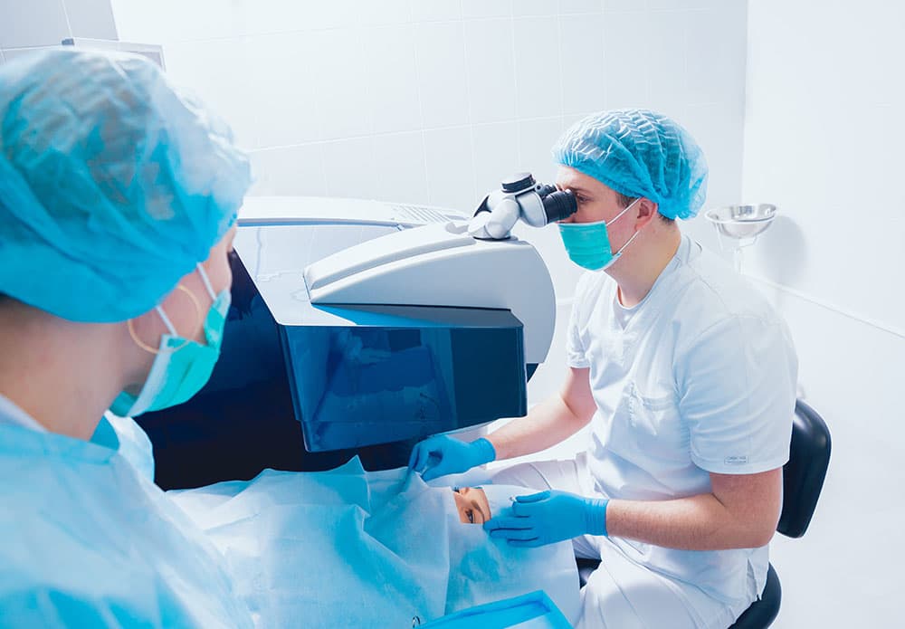 Optometrists preparing a patient for LASIK eye surgery