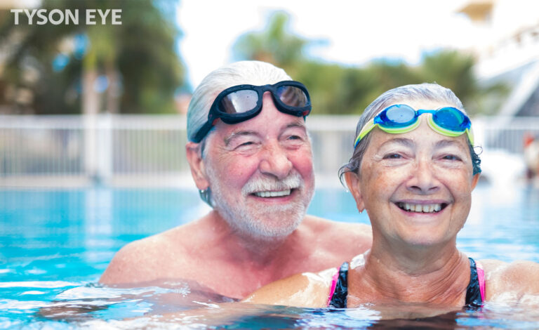 Two people swimming with goggles
